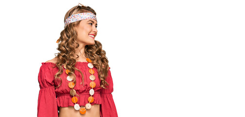 Young blonde girl wearing bohemian and hippie style looking away to side with smile on face, natural expression. laughing confident.