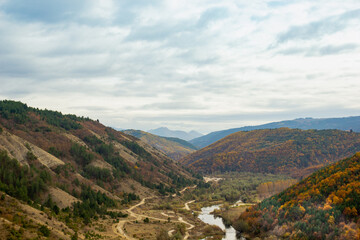 Fototapeta na wymiar autumn in the mountains with river and sky