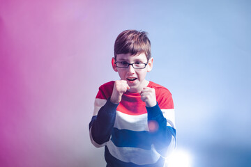 Portrait of young boy in warior pose holding fists