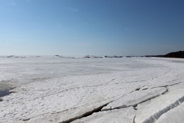 Hummocks on the shoals of the bay under the ice and snow