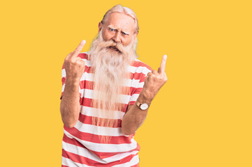 Old senior man with grey hair and long beard wearing striped tshirt showing middle finger doing...