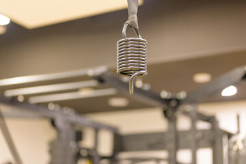 Overhead attachment spring on gym equipment in close up