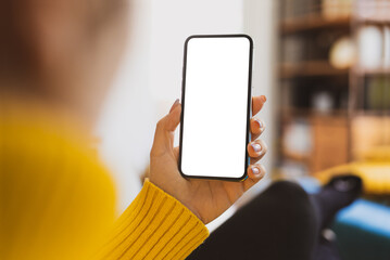 Woman using smartphone frameless mockup blank screen in home interior. Working from home concept - video calling