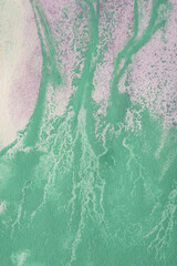 streaks of green paint on paint purple