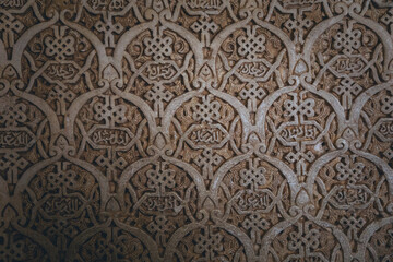 details of the arabesque decorations, typical of the moorish architecture than can be found in the Nasrid palaces of the Alhambra complex in Granada (Spain)
