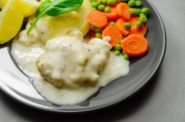 Cod Mornay, flaky cod with a creamy cheese sauce, with mashed potato, peas and carrots