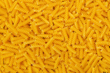 Dry pasta fusilli background. Italian food. Copy space.