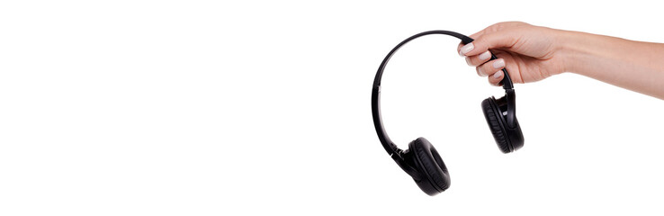 Hand with Wireless black headphones. Isolated on white background.