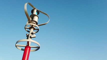 Vertical axis wind turbine producing electric energy with the wind energy, while spinning against blue sky. © ersoy