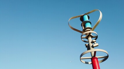 Generating electric energy while Vertical axis wind turbine spinning against blue sky.