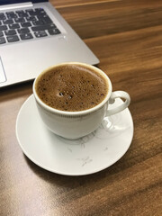 Traditional Turkish coffee is delicious ready for me at the desk.