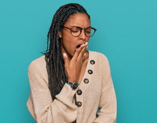 African american woman wearing casual clothes bored yawning tired covering mouth with hand. restless and sleepiness.