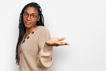 African american woman wearing casual clothes clueless and confused expression with arms and hands...