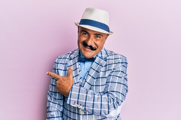Mature middle east man with mustache wearing vintage and elegant fashion style smiling cheerful pointing with hand and finger up to the side