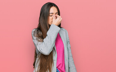 Young hispanic girl wearing business clothes tired rubbing nose and eyes feeling fatigue and headache. stress and frustration concept.