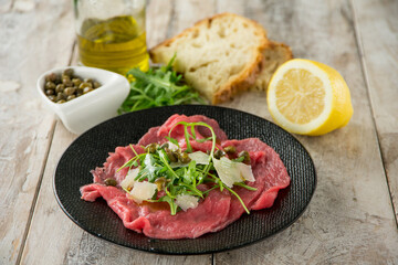 beef carpaccio with arugula capers and parmesan cheese