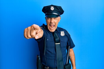 Handsome middle age mature man wearing police uniform pointing displeased and frustrated to the camera, angry and furious with you