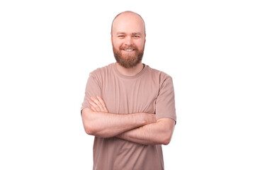 Smiling bearded hipster man standing over white background with crossed arms
