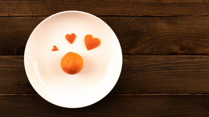 heart made of tangerine peel. postcard, note on a wooden background. gift in a red box