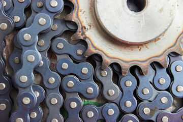 close up background of sprocket with hardened teeth and chain