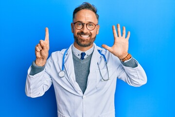 Handsome middle age man wearing doctor uniform and stethoscope showing and pointing up with fingers...