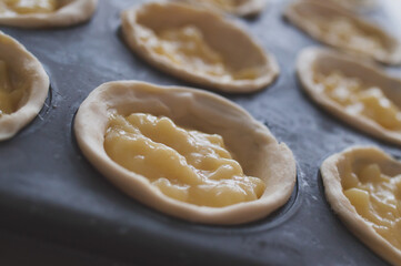 Fototapeta na wymiar Pastel de nata dough with cream close-up 