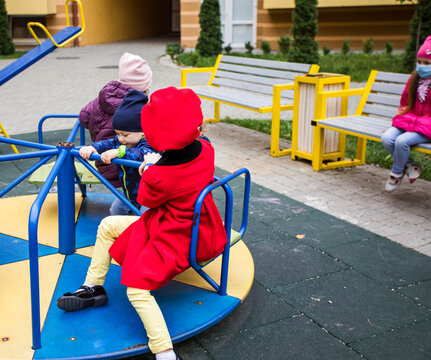 The Group Of Children With A Medical Masks In A City Playground