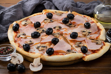 pizza and pizza ingredients. Olives, mushrooms and pizza on a dark background