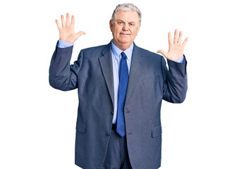 Senior grey-haired man wearing business jacket showing and pointing up with fingers number ten while smiling confident and happy.
