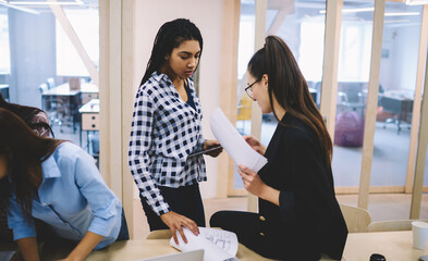 Serious women with documents in office