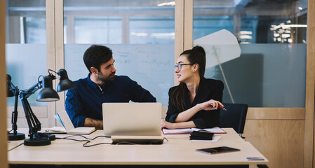 Colleagues talking about details of new project in office