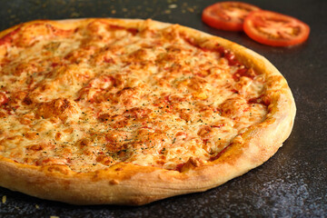 Whole pizza margarita close up on black background