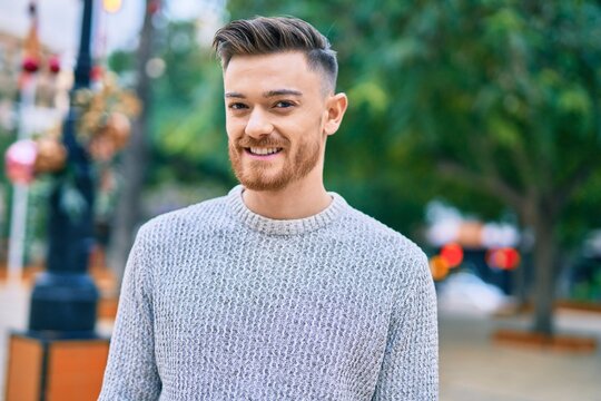 Young caucasian man smiling happy standing at the park.