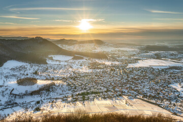 Viewpoint beurener fels with castle hohenneuffen at the swabian jura at sunset in winter with snow very cold, germany, baden-württemberg