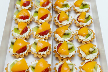 Fruits tarts served on a tray for a party. Sweet dessert.