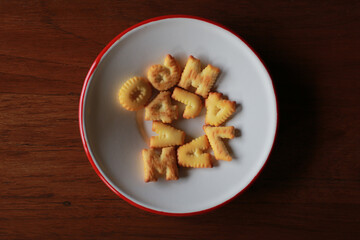 A heap of biscuit or cracker with the letter alphabet