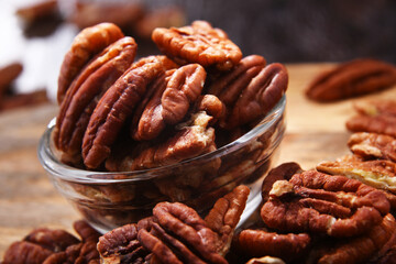 Composition with a bowl of shelled pecan nuts. Delicacies