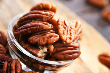 Composition with a bowl of shelled pecan nuts. Delicacies