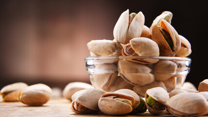 Composition with bowl of in shell pistachios. Delicacies