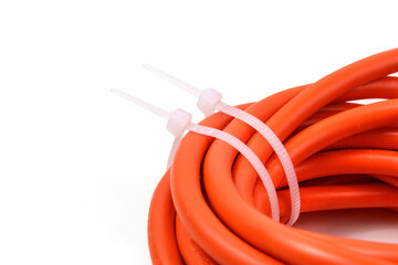 White cable ties on orange cable. Close up.