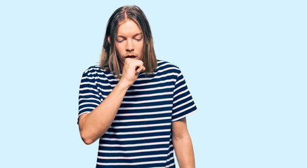 Handsome caucasian man with long hair wearing casual striped t-shirt feeling unwell and coughing as symptom for cold or bronchitis. health care concept.