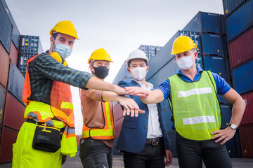Engineer team people standing with their hands together at the container yard and check for control loading Containers box from Cargo freight ship for import and export. Team Teamwork Concept