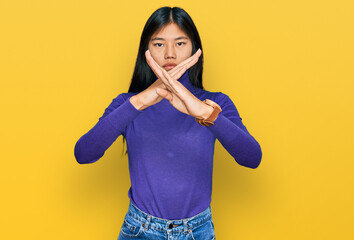 Fototapeta premium Beautiful young asian woman wearing casual clothes rejection expression crossing arms and palms doing negative sign, angry face
