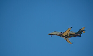 Fototapeta na wymiar Private jet with a blue sky background shot from ground level