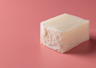handmade salt soap bar on coral background