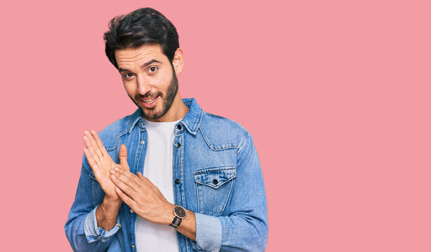 Young hispanic man wearing casual clothes clapping and applauding happy and joyful, smiling proud hands together