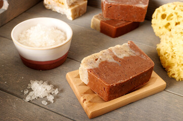 Bath salt and organic soap bar on wooden tray. Natural cosmetics.