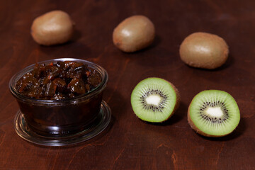 Kiwifruit jam in glass jar. Homemade caramelized kiwi fruit sweets.