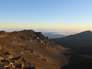 a sunrise over the clouds at the Haleakala volcano on Maui island, Hawaii, January