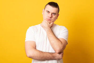 Portrait of a pensive young man in a T-shirt.